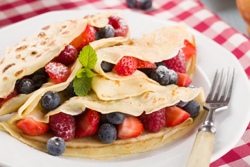 Delicious pancakes with raspberries, blueberries and strawberrie