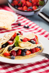 Delicious pancakes with raspberries, blueberries and strawberrie