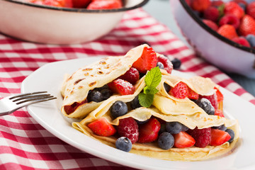 Delicious pancakes with raspberries, blueberries and strawberrie