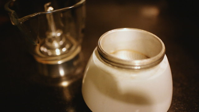 pouring raw coffee in moca with a spoon