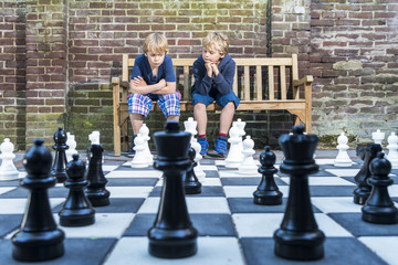 Boys playing outdoor chess