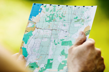 Man holding a map  in his hand.