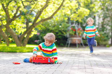 Little preschool boy playing with car toy