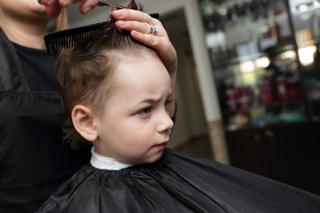 Serious kid at the barbershop