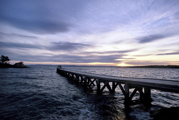 Obraz premium Sunset in lake. Pier