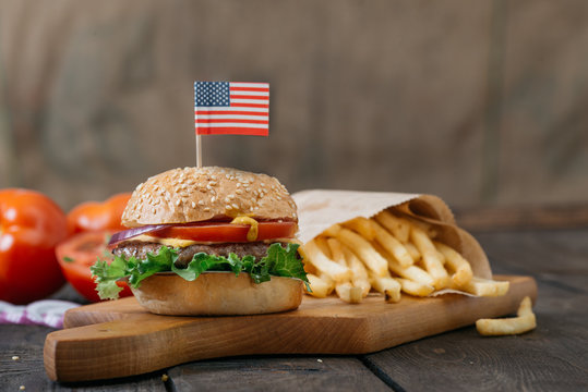 American  beef burgers with cheese and USA flags, on the  wooden table.