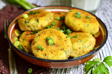 Homemade potato patties with herbs and green onion.