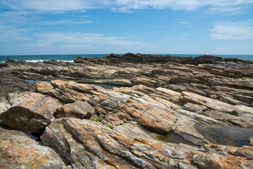 Rocky coast landscape with metamorphic rocks and splashing foaming waves, Southern Province, Sri Lanka, Asia.