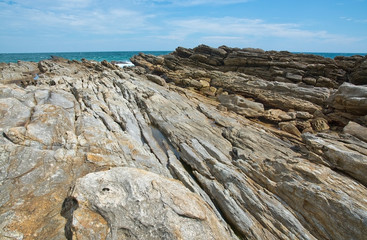 Rocky coast landscape with metamorphic rocks and splashing foaming waves, Southern Province, Sri Lanka, Asia.