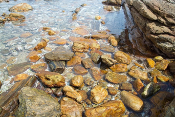 Smooth rocks in clear ocean water, Sri Lanka, Asia.
