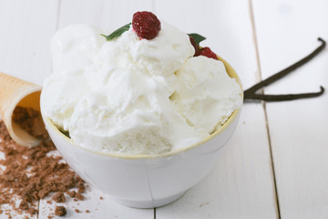 Vanilla Ice Cream on the white wooden table. 
