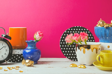 Website header design with colorful objects over pink background