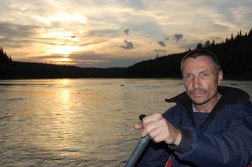 Portrait of water tourist at sunset. Kola Peninsula, Russia.