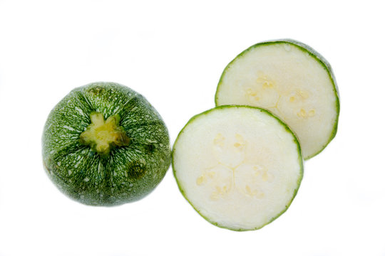Round zucchini on a white background seen from above