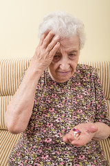 ill senior woman taking pill