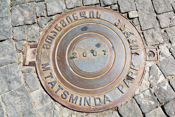 Manhole on cobblestone road. Tbilisi. Georgia