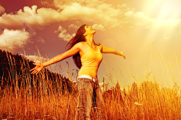 girl standing in a field looking to the sky-summerfield 02