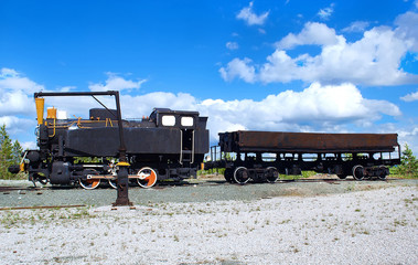 Old soviet locomotive on a background of blue sky