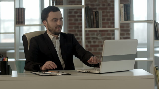 Businessman on video conference with his colleague in office job