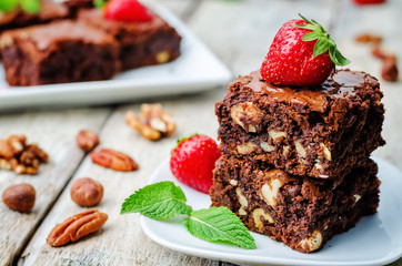 chocolate nut brownie cake decorated with strawberries
