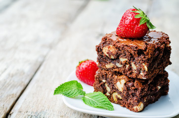 chocolate nut brownie cake decorated with strawberries
