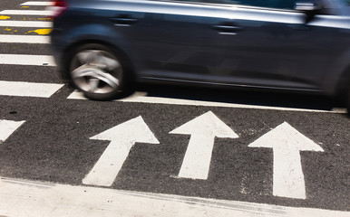 pedestrian crossing with arrows indicating the direction of in a modern city