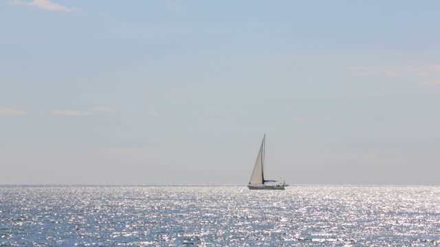 Sailboat Slowly Floating In The Sea
