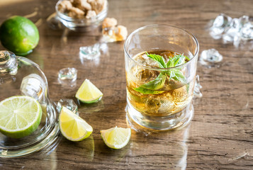 Glass of rum on the wooden background