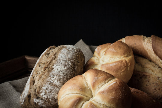 various rolls of wheat on a background of a wooden table