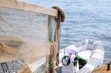 Railing Draped in Fishing Net on Dock with Boat