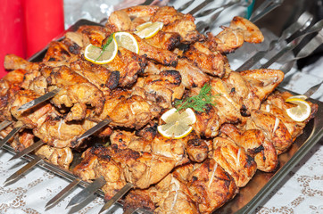 Appetizing hot shish kebab on metal skewers