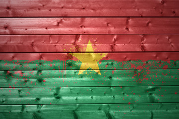 painted burkina faso flag on a wooden texture