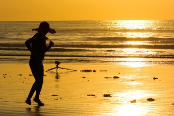 silhouette of girl  running on the beach