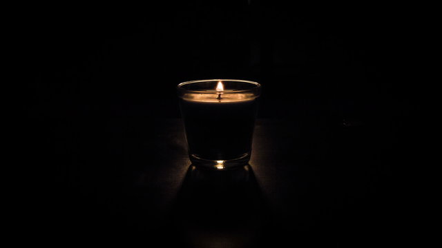Small candle against dark background