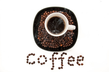 cup with coffee on the plate with coffee beans