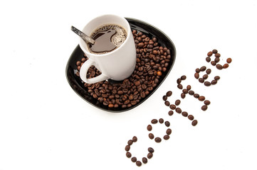cup with coffee on the plate with coffee beans