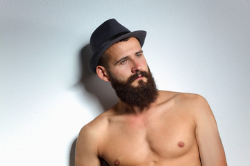 Portrait of handsome bearded man standing, isolated on grey