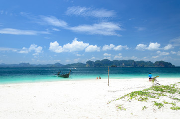Tourists on a tropical beach with boat  inthaland