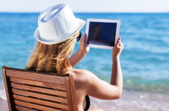 Tablet, beach, chair.