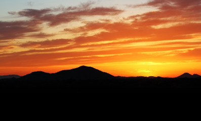 Desert Sunset – Desert Sunset with bright colors and mountains in background