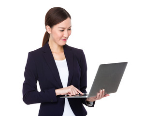Asian businesswoman type on the notebook computer