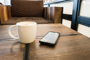 A cup of coffee latte and smart phone