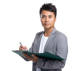 Young businessman write on clipboard