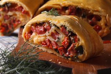 homemade strudel with ham, cheese and fresh vegetables macro