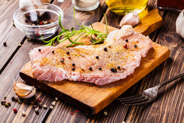 Raw pork slices prepared for roast with spices