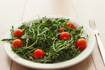 summer salad with tomatoes on wooden table