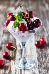 Fruit ice cream dessert with sweet cherry  in martini glass