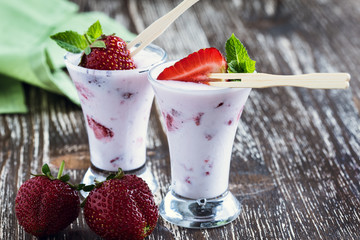 Frozen fruit smoothies with fresh strawberries on top