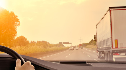 Commuter Traffic - Driving a car on an expressway/motorway at sunset
