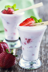 Frozen fruit smoothies with fresh strawberries on top